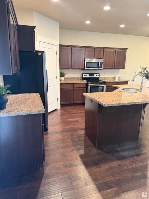 1024 W 700 S, Pleasant Grove, UT 84062 - kitchen with dark wood-type flooring, sink, appliances with stainless steel finishes, light stone counters, and dark brown cabinetry