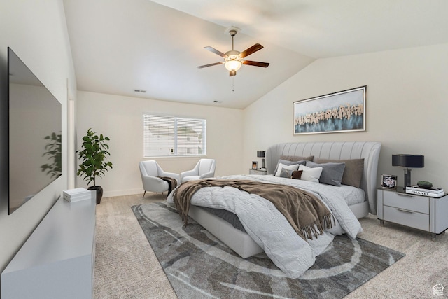 bedroom featuring ceiling fan, light colored carpet, and vaulted ceiling
