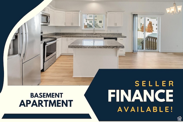 kitchen featuring white cabinets, light wood-type flooring, stainless steel appliances, and sink
