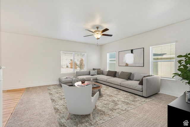 living room with light hardwood / wood-style floors and ceiling fan