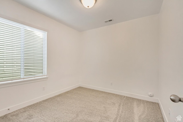 carpeted empty room with a healthy amount of sunlight