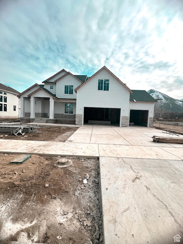 modern inspired farmhouse with an attached garage and concrete driveway