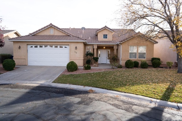 715 Lobo Ln, Washington, UT 84780 - view of front of house featuring a garage and a front lawn