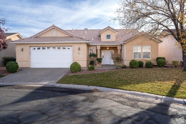 715 Lobo Ln, Washington, UT 84780 - view of front facade featuring a front lawn and a garage