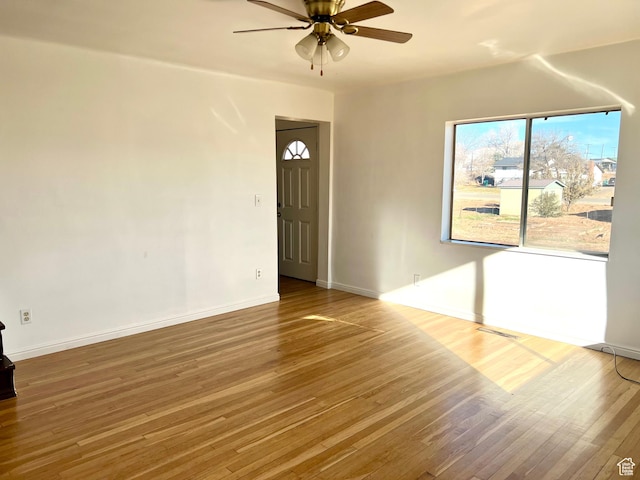 unfurnished room with wood-type flooring and ceiling fan