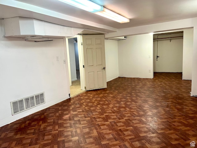 basement with dark parquet floors