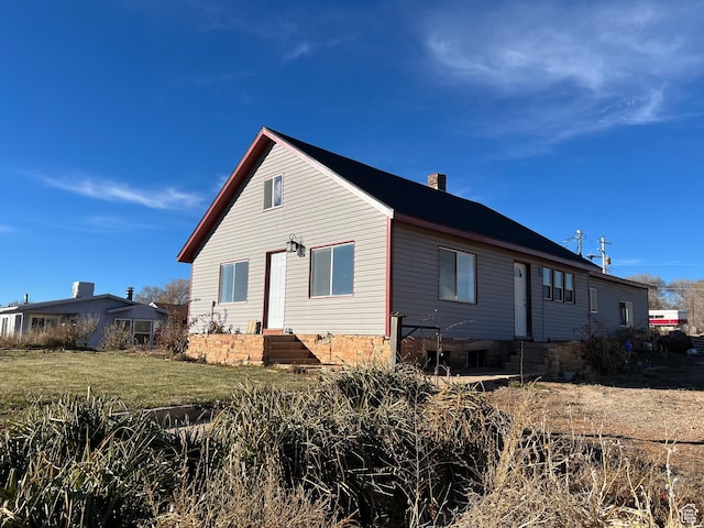 view of home's exterior with a yard