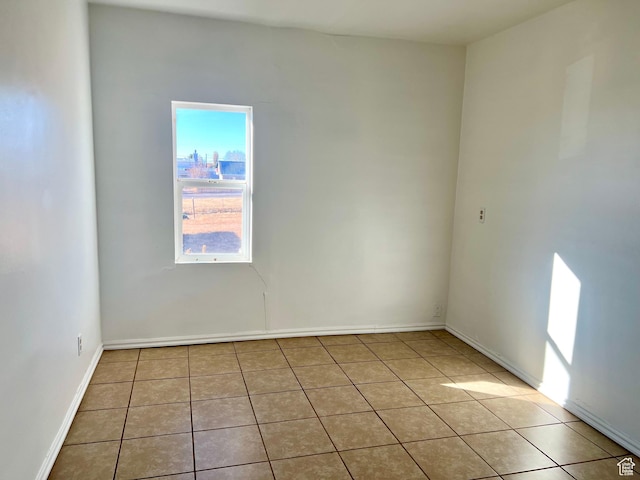 unfurnished room featuring light tile patterned floors