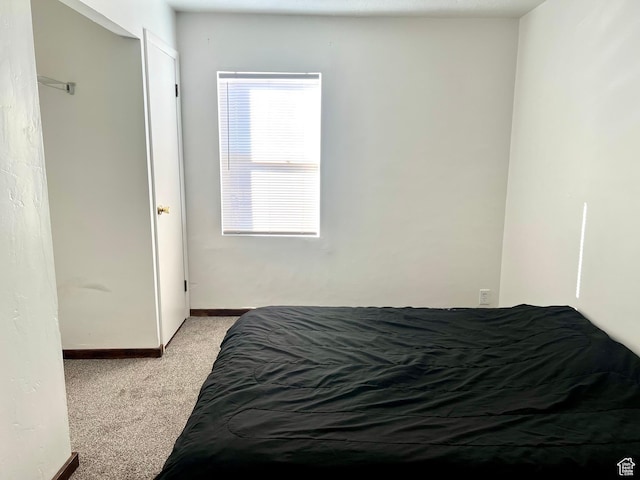 bedroom with light colored carpet