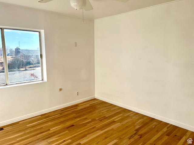 spare room featuring ceiling fan and hardwood / wood-style floors