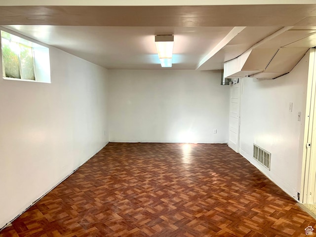 basement featuring dark parquet floors
