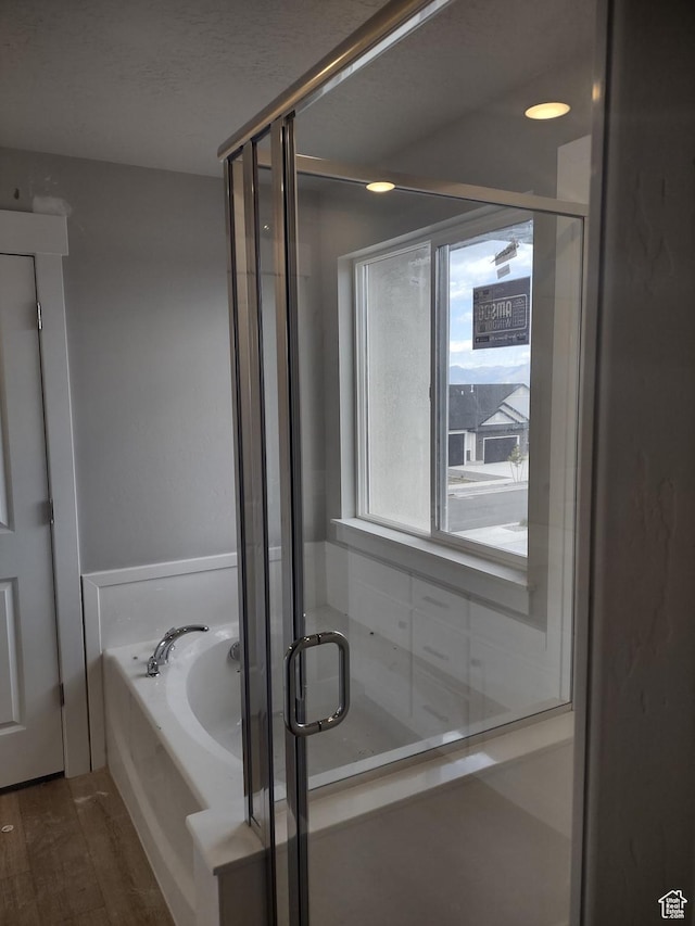 7497 W Sage Slope Way, Herriman, UT 84096 - full bathroom featuring a garden tub, a stall shower, and wood finished floors