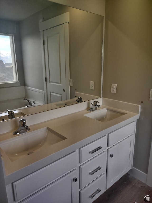 7497 W Sage Slope Way, Herriman, UT 84096 - full bathroom with double vanity, wood finished floors, and a bath
