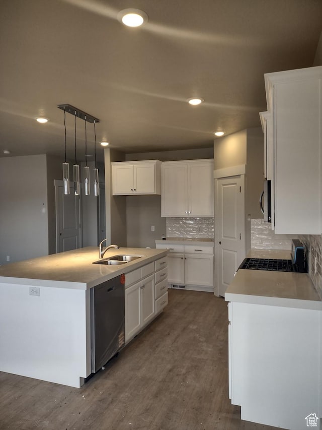 7497 W Sage Slope Way, Herriman, UT 84096 - kitchen with stainless steel appliances, a sink, white cabinetry, decorative backsplash, and an island with sink