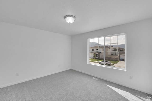 458 W Lefty Ln Unit 1129, Stansbury Park, UT 84074 - carpeted spare room featuring baseboards