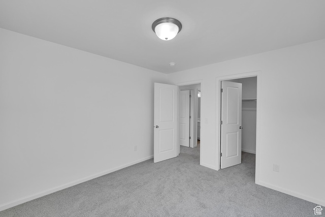 458 W Lefty Ln Unit 1129, Stansbury Park, UT 84074 - unfurnished bedroom featuring carpet flooring, baseboards, and a walk in closet