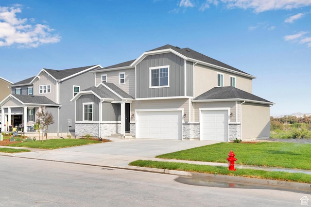 458 W Lefty Ln Unit 1129, Stansbury Park, UT 84074 - view of front facade featuring an attached garage, stone siding, concrete driveway, and board and batten siding