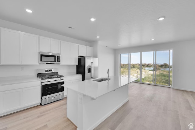 458 W Lefty Ln Unit 1129, Stansbury Park, UT 84074 - kitchen featuring stainless steel appliances, light wood-type flooring, a sink, white cabinets, and recessed lighting