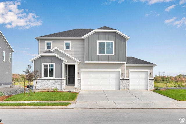 458 W Lefty Ln Unit 1129, Stansbury Park, UT 84074 - craftsman-style house featuring board and batten siding, stone siding, concrete driveway, and a front lawn