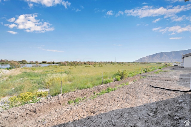 458 W Lefty Ln Unit 1129, Stansbury Park, UT 84074 - view of yard featuring a water and mountain view