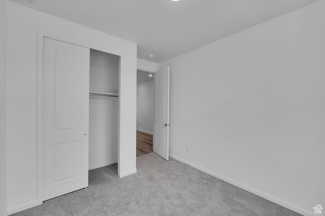 458 W Lefty Ln Unit 1129, Stansbury Park, UT 84074 - unfurnished bedroom featuring carpet flooring, a closet, and baseboards