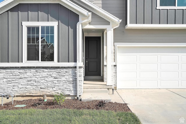 458 W Lefty Ln Unit 1129, Stansbury Park, UT 84074 - doorway to property featuring stone siding, an attached garage, and concrete driveway