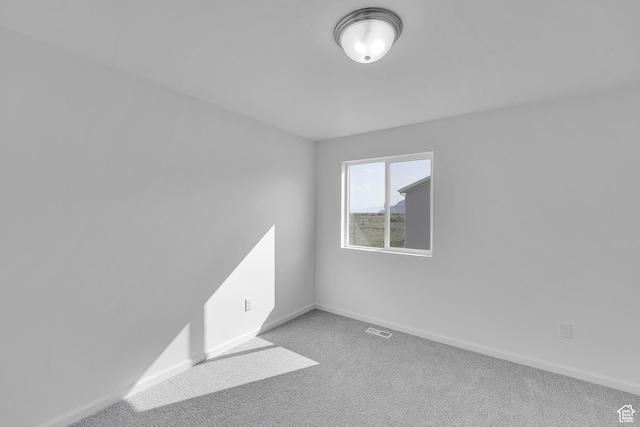 458 W Lefty Ln Unit 1129, Stansbury Park, UT 84074 - empty room with carpet flooring and baseboards