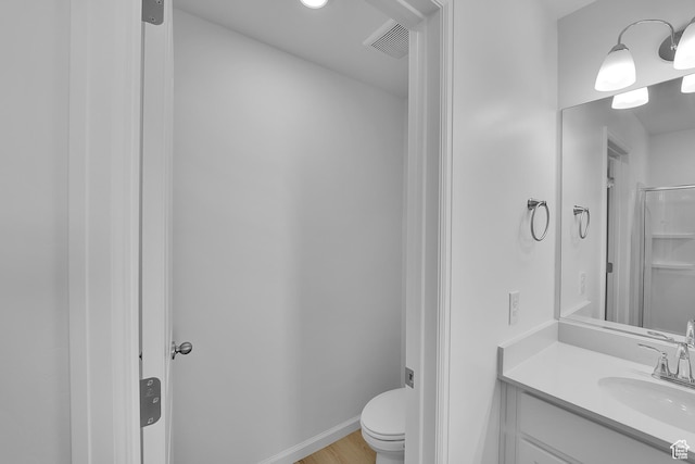 458 W Lefty Ln Unit 1129, Stansbury Park, UT 84074 - bathroom with toilet, vanity, and wood finished floors