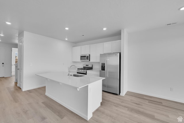 458 W Lefty Ln Unit 1129, Stansbury Park, UT 84074 - kitchen featuring stainless steel appliances, a sink, a center island with sink, white cabinetry, and recessed lighting