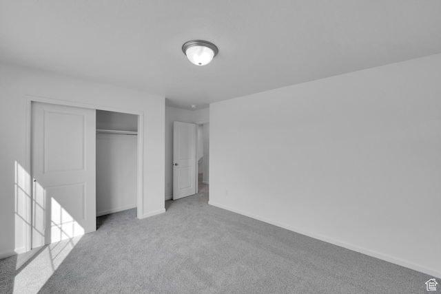 458 W Lefty Ln Unit 1129, Stansbury Park, UT 84074 - unfurnished bedroom featuring carpet floors, baseboards, and a closet