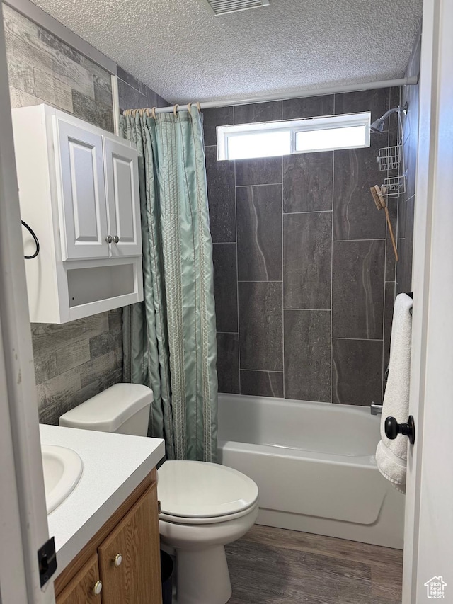 972 E Ridgeway Loop Unit 228, Garden City, UT 84028 - full bath with shower / bath combo with shower curtain, vanity, toilet, a textured ceiling, and wood finished floors