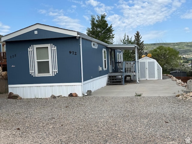 972 E Ridgeway Loop Unit 228, Garden City, UT 84028 - view of side of home with a patio and a deck