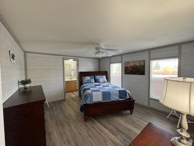 972 E Ridgeway Loop Unit 228, Garden City, UT 84028 - bedroom featuring a textured ceiling, wood finished floors, wood walls, and ceiling fan