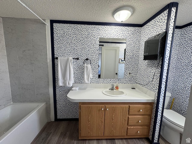 972 E Ridgeway Loop Unit 228, Garden City, UT 84028 - full bathroom featuring a textured ceiling, vanity, wood finished floors, toilet, and tile walls