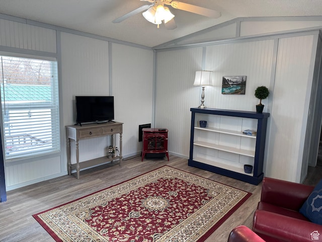 972 E Ridgeway Loop Unit 228, Garden City, UT 84028 - living area with wood finished floors, ceiling fan, lofted ceiling, a wood stove, and baseboards