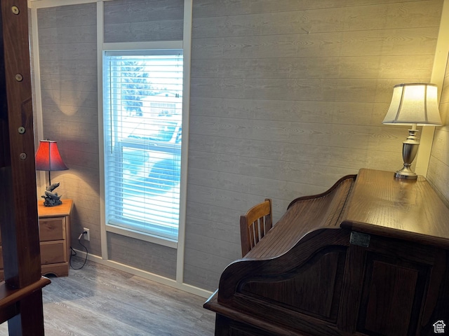 972 E Ridgeway Loop Unit 228, Garden City, UT 84028 - bedroom with wood finished floors, multiple windows, baseboards, and wood walls