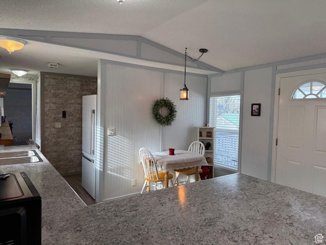 972 E Ridgeway Loop Unit 228, Garden City, UT 84028 - kitchen featuring lofted ceiling, dark wood-type flooring, high quality fridge, stove, and a sink