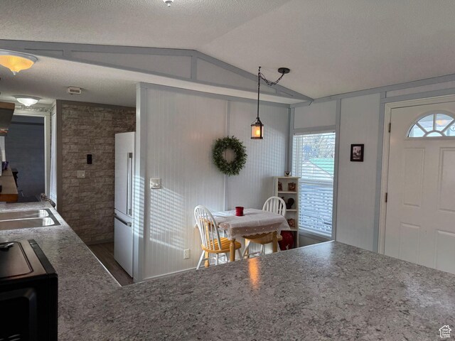 972 E Ridgeway Loop Unit 228, Garden City, UT 84028 - kitchen featuring lofted ceiling, dark wood-type flooring, high quality fridge, stove, and a sink