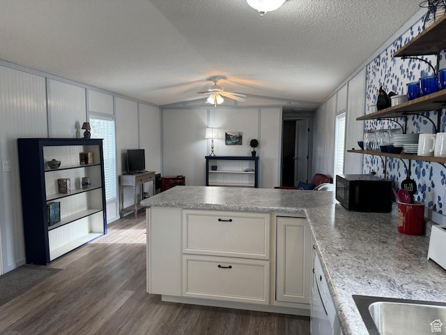972 E Ridgeway Loop Unit 228, Garden City, UT 84028 - kitchen featuring open shelves, a peninsula, black microwave, ceiling fan, and dark wood-type flooring