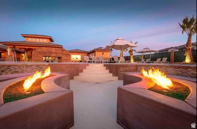 355 N 2020 W, Hurricane, UT 84737 - patio terrace at dusk featuring a fireplace and a fire pit