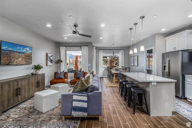 355 N 2020 W, Hurricane, UT 84737 - living room with ceiling fan, dark wood-type flooring, and a textured ceiling