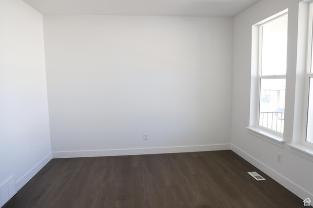 2892 Liam Ln N Unit 140, Eagle Mountain, UT 84005 - unfurnished room with dark wood-style flooring, visible vents, and baseboards
