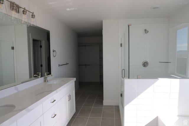 2892 Liam Ln N Unit 140, Eagle Mountain, UT 84005 - bathroom featuring tile patterned flooring, a sink, a spacious closet, a shower stall, and double vanity