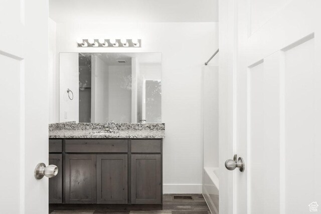 1151 W High Plains Dr Unit 605, Grantsville, UT 84029 - bathroom featuring hardwood / wood-style floors, vanity, and shower / bathtub combination