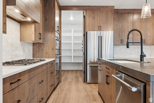 741 S 1800 W, Hurricane, UT 84737 - kitchen featuring dark stone countertops, a sink, custom range hood, and appliances with stainless steel finishes