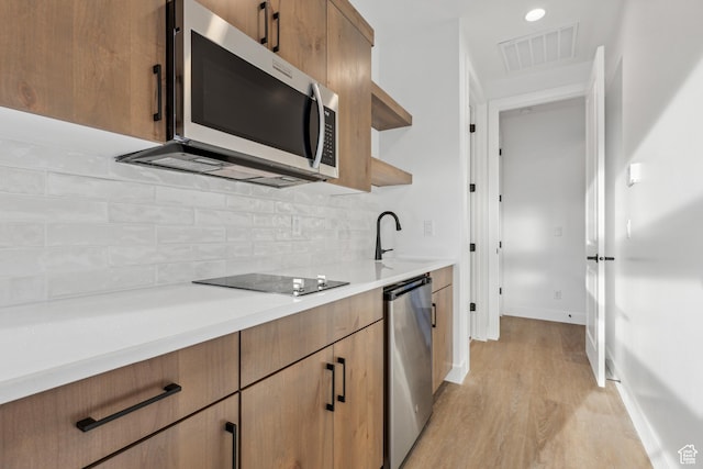 741 S 1800 W, Hurricane, UT 84737 - kitchen with open shelves, light wood-style floors, appliances with stainless steel finishes, backsplash, and visible vents