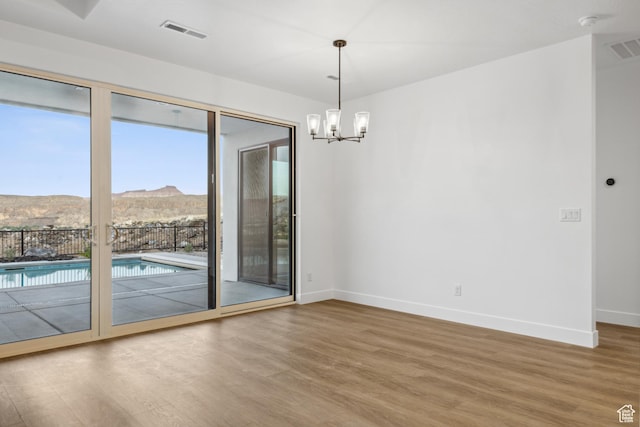 741 S 1800 W, Hurricane, UT 84737 - spare room featuring baseboards, visible vents, wood finished floors, and a chandelier