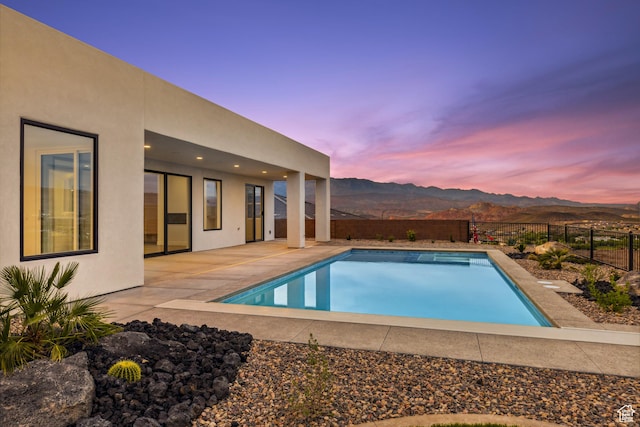741 S 1800 W, Hurricane, UT 84737 - pool at dusk with a patio, a mountain view, a fenced backyard, and a fenced in pool