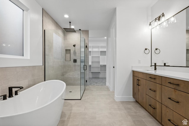 741 S 1800 W, Hurricane, UT 84737 - bathroom with tile patterned floors, a freestanding bath, a shower stall, vanity, and a spacious closet