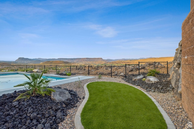 741 S 1800 W, Hurricane, UT 84737 - view of yard with a fenced in pool, a mountain view, and a fenced backyard